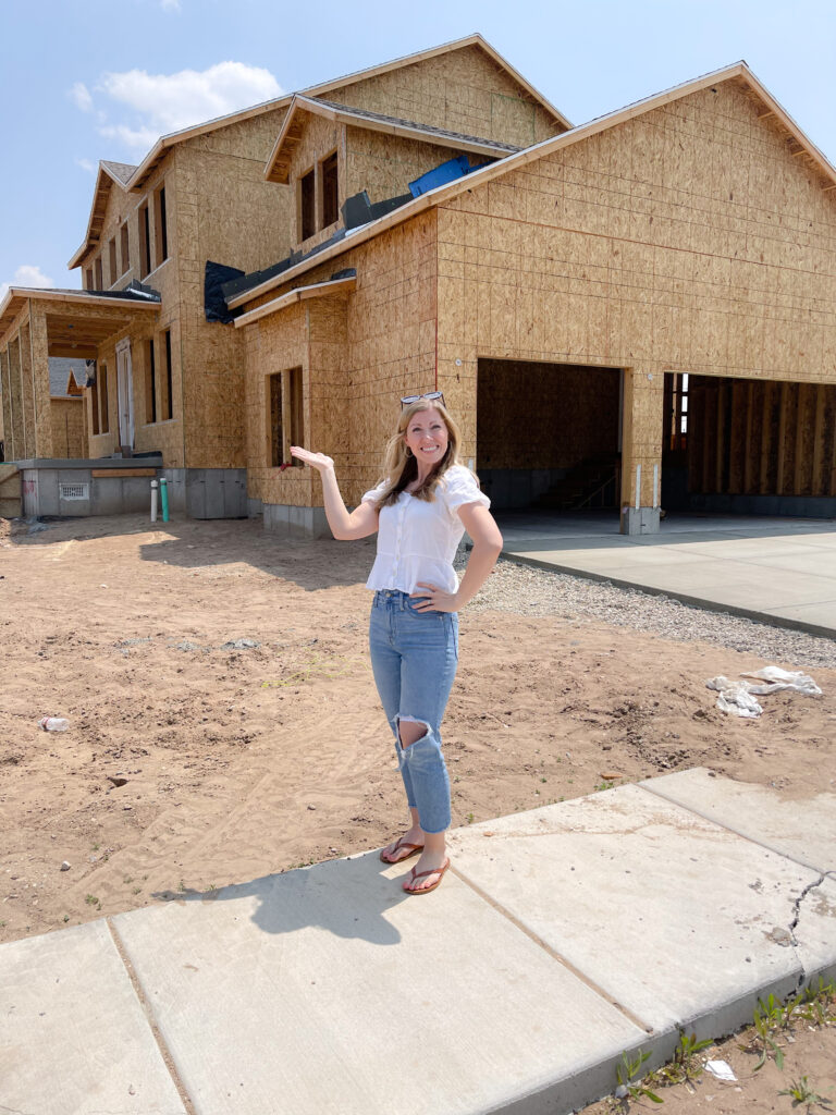 woman standing in front of half build house