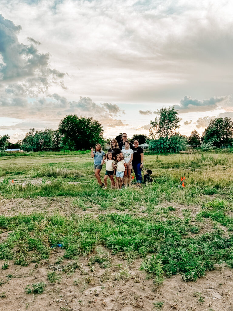 Family of 7 standing in a field