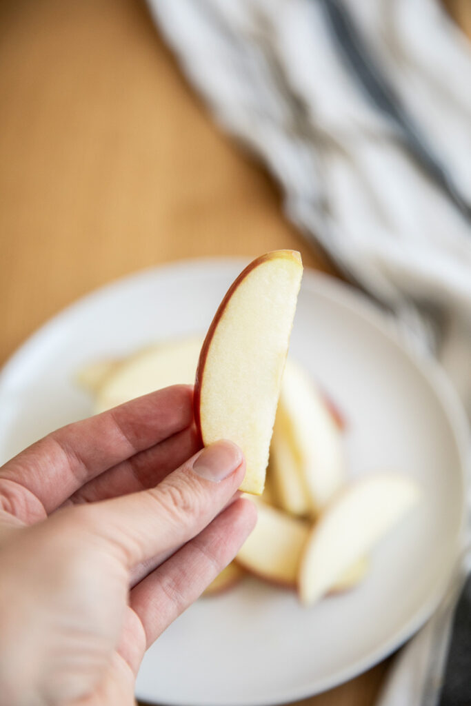 hand holding sliced apple