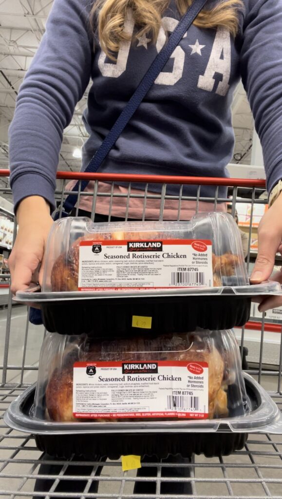two costco rotisserie chickens stacked in cart