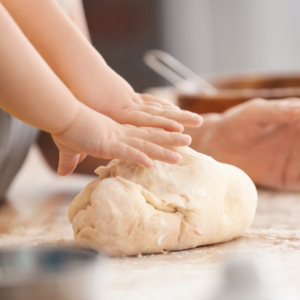baby hands kneading dough