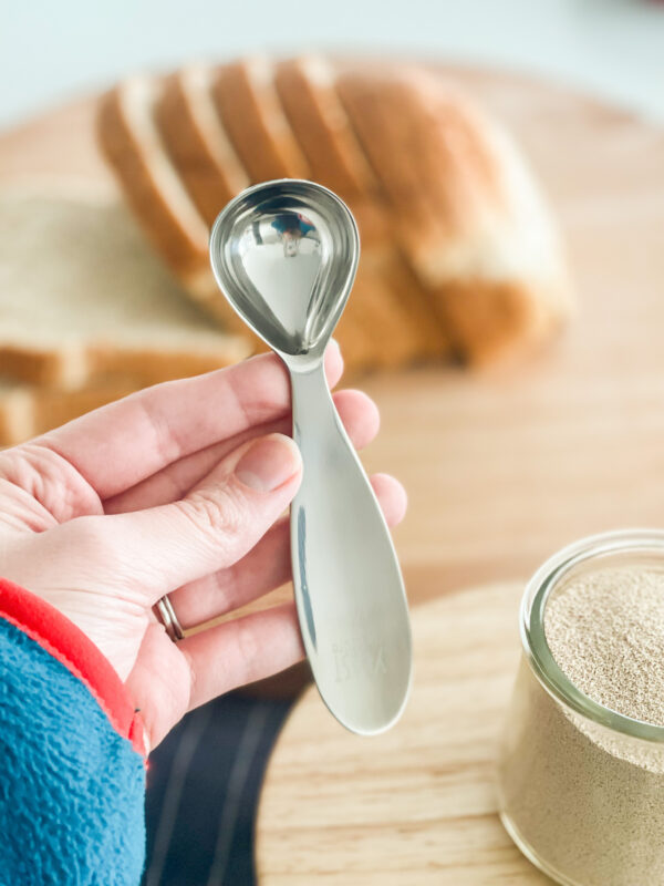 hand holding yeast spoon
