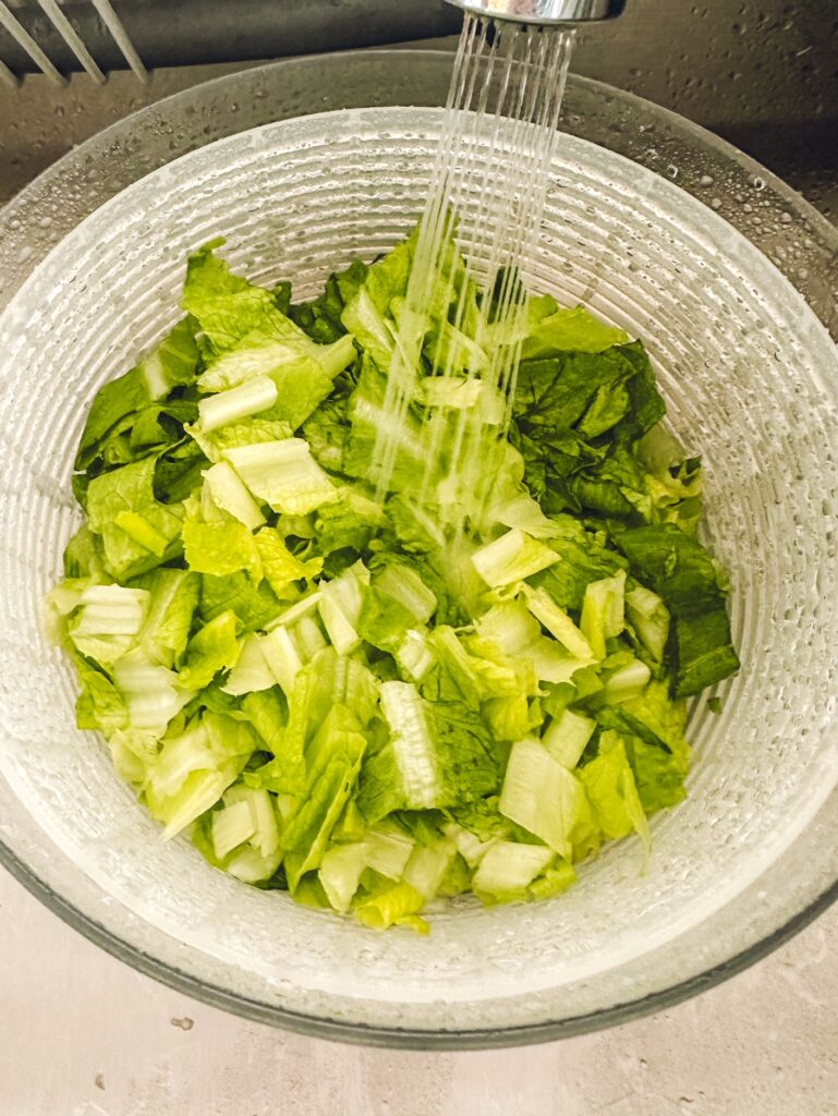 chopped up lettuce being washed